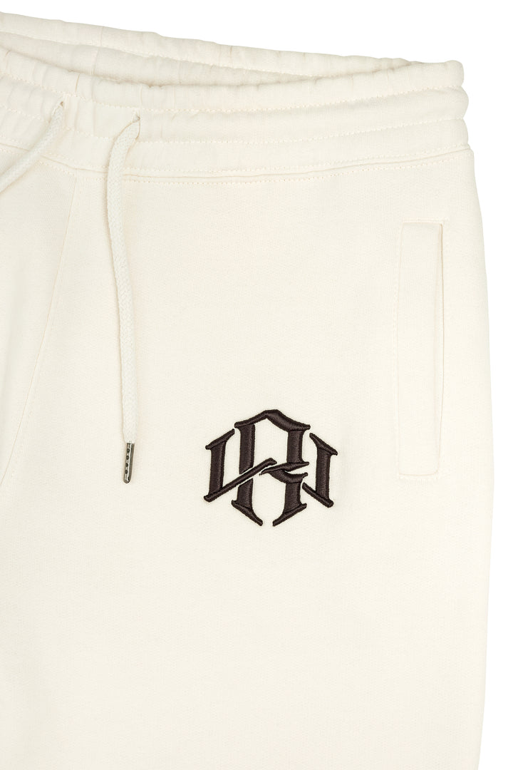 RENOWNED WEAR Premium 400gsm Heavyweight Cream Sweatpants close up 3D Embroidery detail.