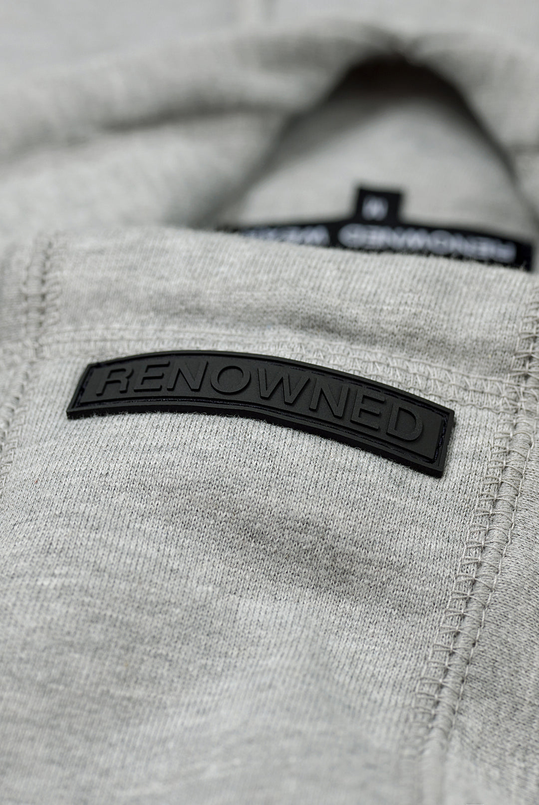 Rubber Label Detail of Heather Grey Premium 400gsm Heavyweight Hoodie by RENOWNED WEAR