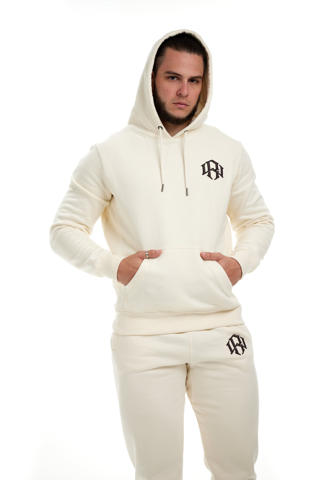 Young man modeling/wearing the Cream Colored Premium 400gsm Heavyweight Hoodie
