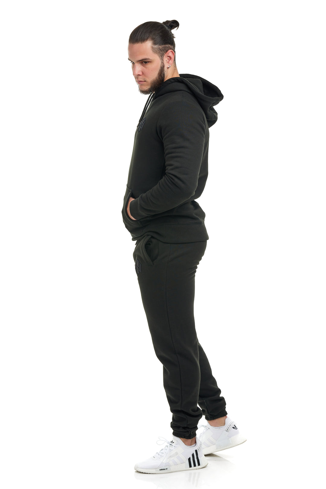 Young man modeling/wearing the Black Colored Premium 400gsm Heavyweight Sweatpants by RENOWNED WEAR