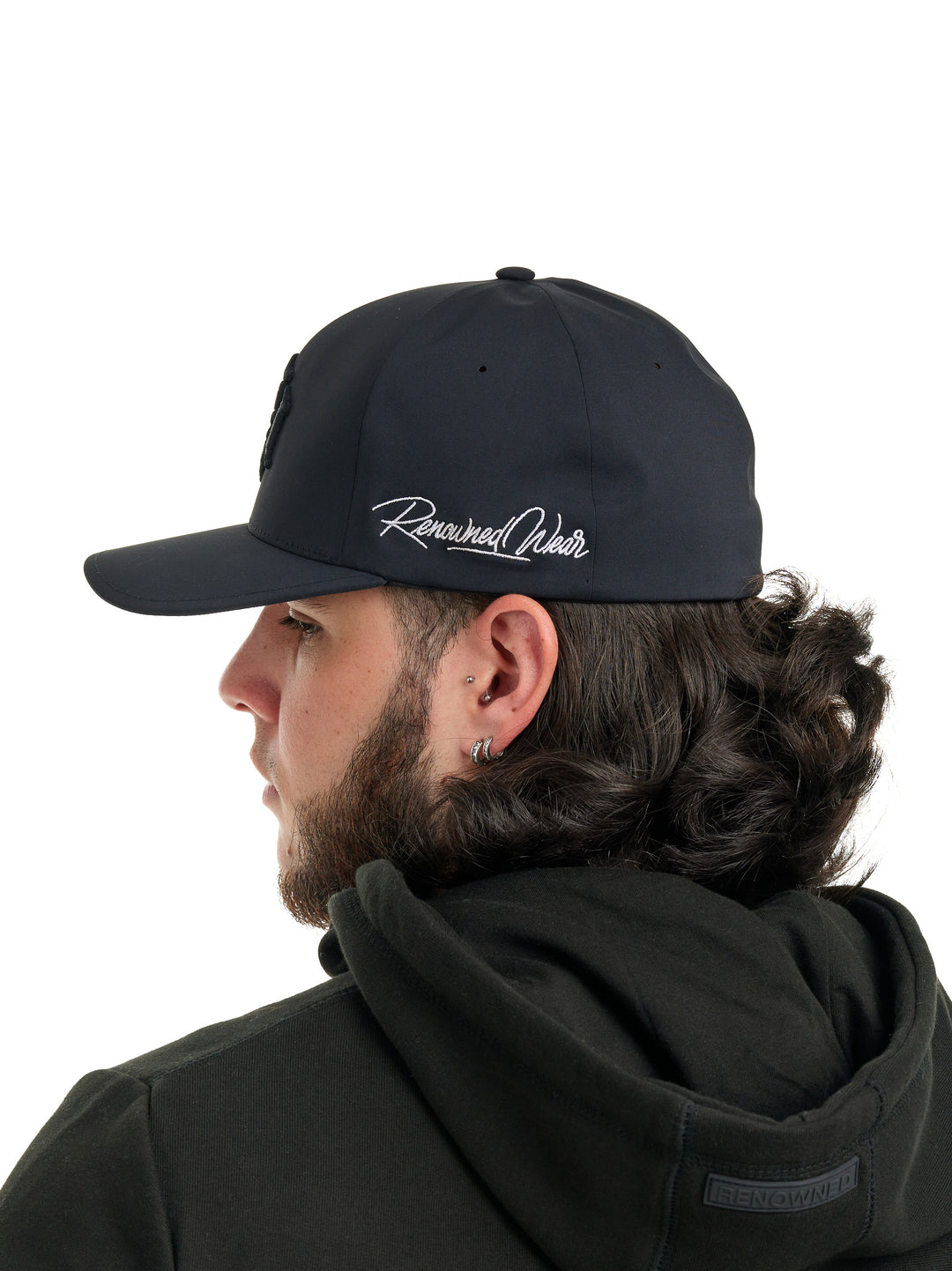 Young man wearing a Renowned Wear Black Motif Performance Baseball Cap with 3D Embroidery