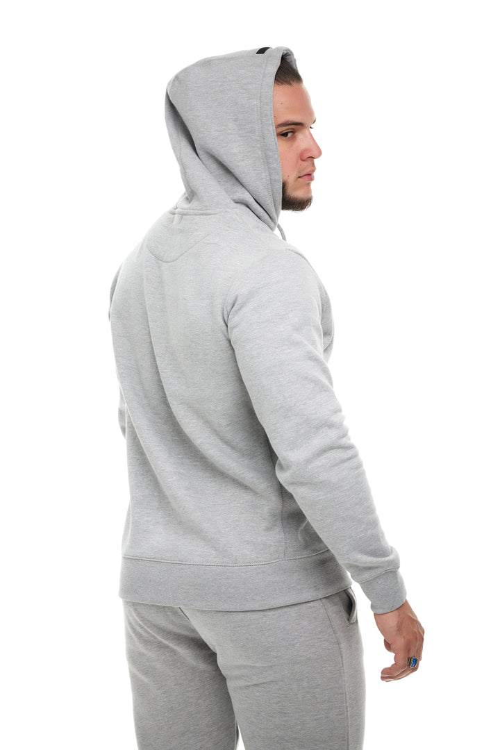 Young man modeling the Heather Grey Premium 400gsm Heavyweight Hoodie by RENOWNED WEAR