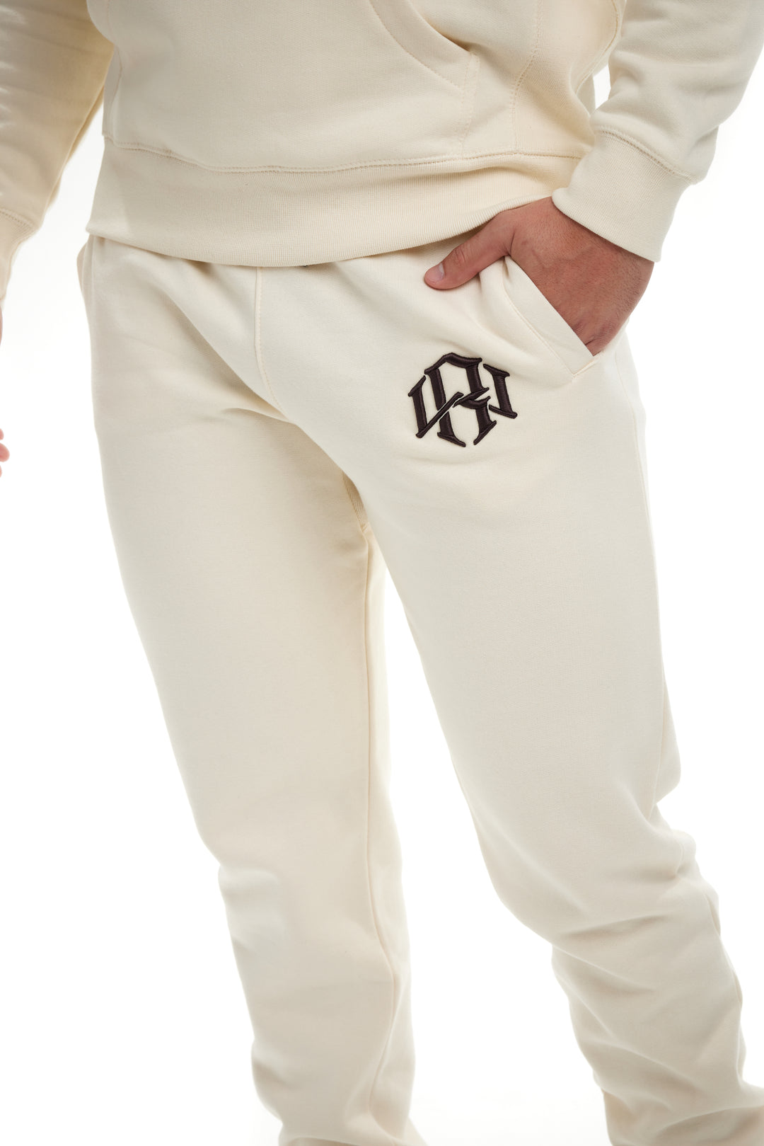 Premium 400gsm Heavyweight Cream Sweatpants modeled by a young man 